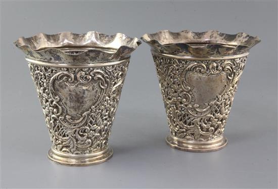 A pair of late Victorian pierced repousse silver vases by James Deakin & Sons, height 17.2cm.